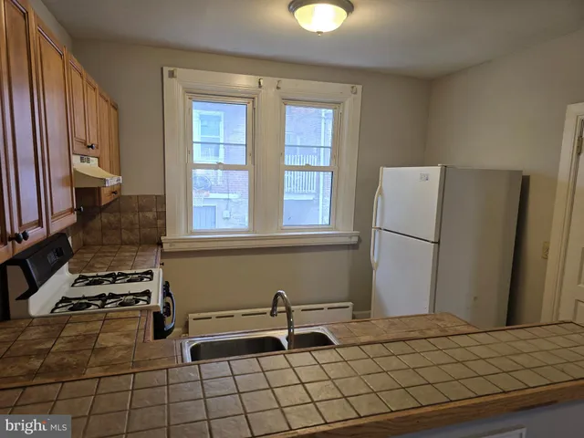 a kitchen with a sink and a refrigerator