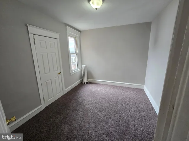 an empty room with windows and entrance