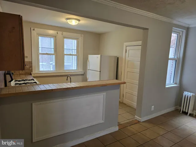 a kitchen with stainless steel appliances a sink stove and a refrigerator