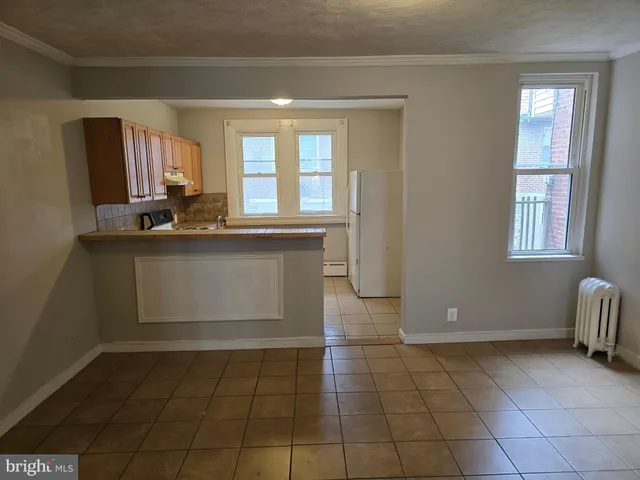 a kitchen with a sink cabinets and window