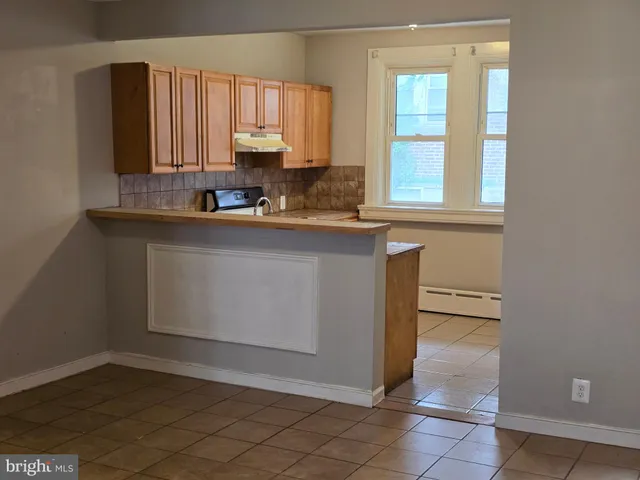 a kitchen with a sink window and cabinets