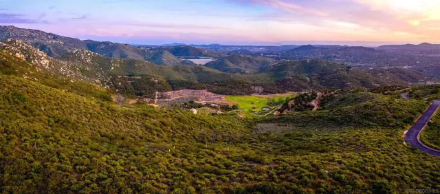 a view of a large mountain with mountains in the background