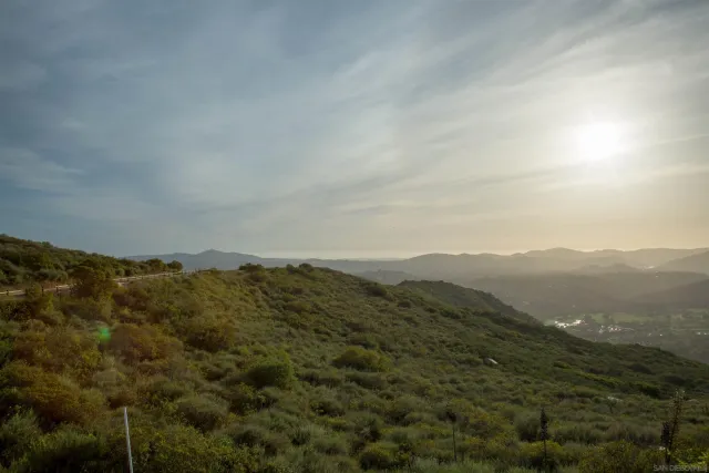 a view of a wooden house with a flower garden