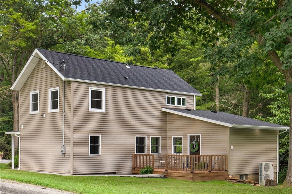a house that has a tree in front of the house