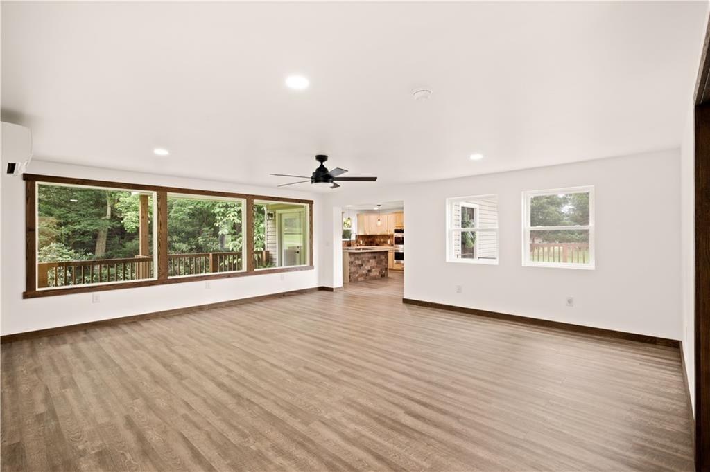 480 Freeman Falls Road Acme, PA 15610 - Photo 12 of 45 a view of an empty room with wooden floor and a window