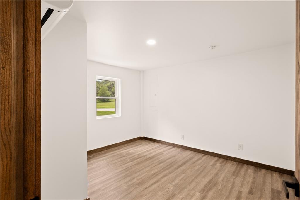 480 Freeman Falls Road Acme, PA 15610 - Photo 14 of 45 a view of an empty room with wooden floor and a window