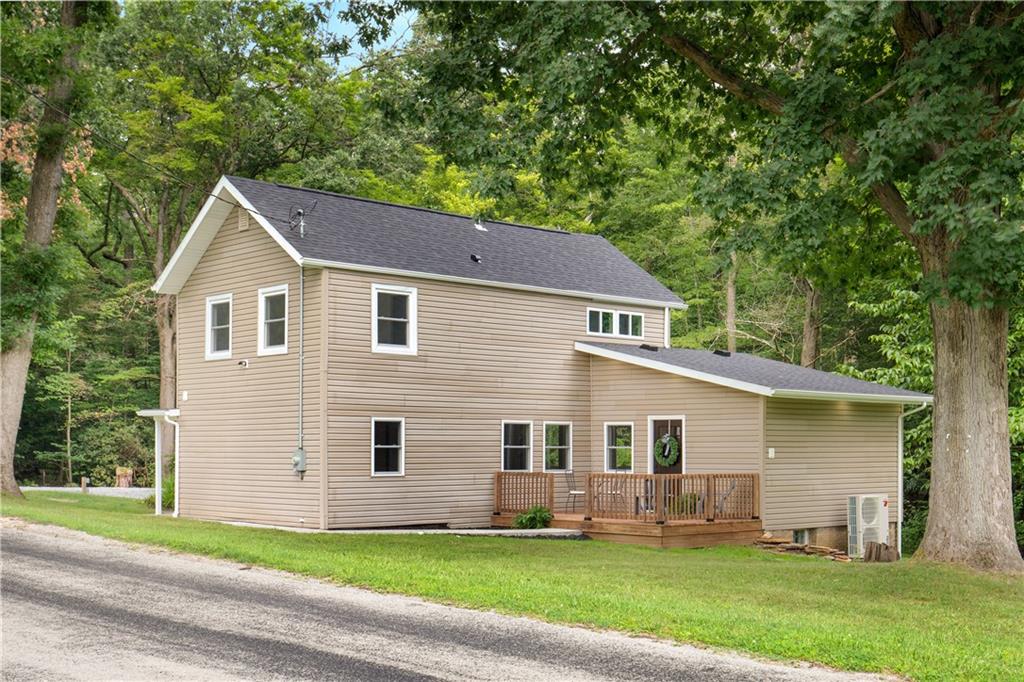 480 Freeman Falls Road Acme, PA 15610 - Photo 30 of 45 a front view of a house with a yard and garage