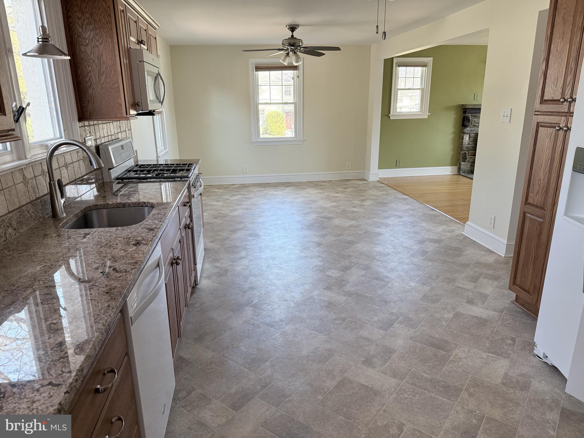 302 South Valley Forge Road Devon, PA 19333 - Photo 9 of 28 a kitchen with granite countertop a sink stove and cabinets