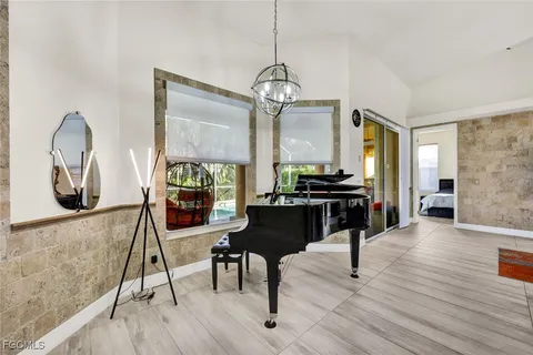 a living room with furniture and a chandelier