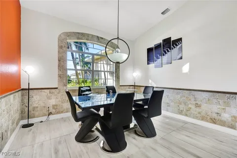 a dining room with furniture and window