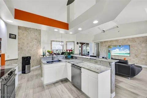 a kitchen with stainless steel appliances granite countertop a sink and cabinets
