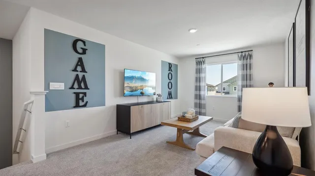 a living room with furniture a desk and chair with wooden floor