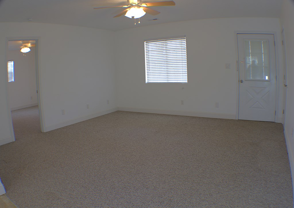 125 Moore View Drive Murphy, NC 28906 - Photo 5 of 49 an empty room with a chandelier fan and windows