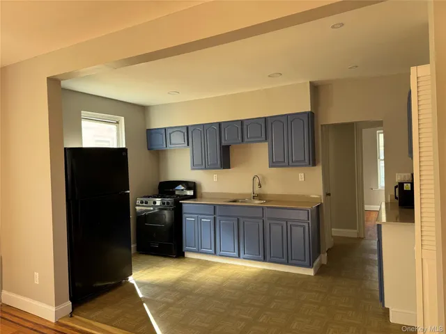 a kitchen with stainless steel appliances granite countertop a refrigerator stove and sink