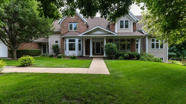 a front view of a house with a yard and porch