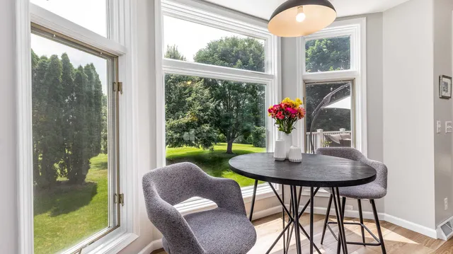 a view of a dining room with furniture window and wooden floor