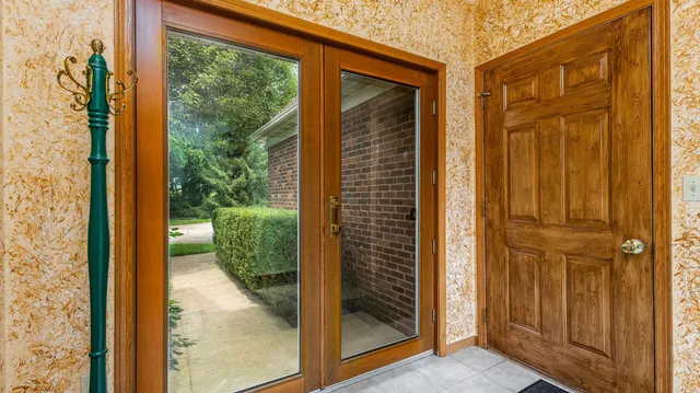 a living room with furniture a ceiling fan fireplace and a large window