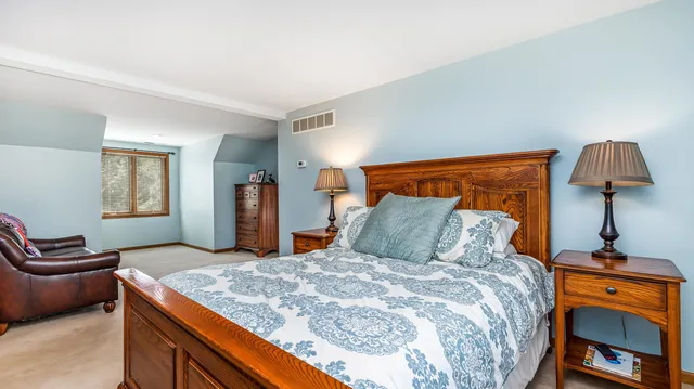 a view of a hallway with workspace and a window