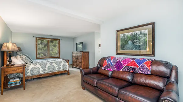 a dining room with furniture and a rug