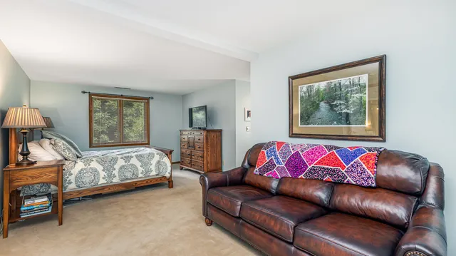 a dining room with furniture and a rug