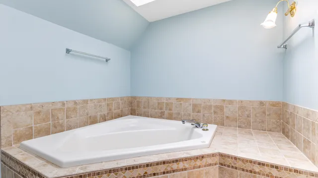a view of a double vanity sink and a window in a room
