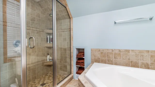 a view of a patio with table and chairs and a large tree