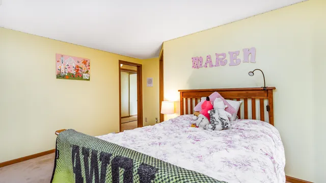 an aerial view of a residential houses with outdoor space and trees