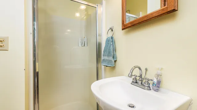 an aerial view of a house with a big yard and large trees