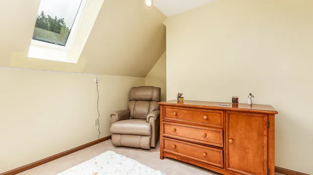 an aerial view of residential house with outdoor space and trees all around