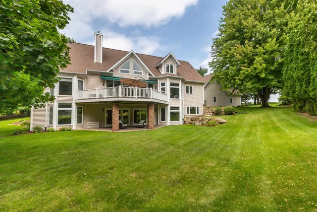 an aerial view of a houses with outdoor green space