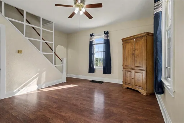 a view of an entryway with wooden floor and cabinet