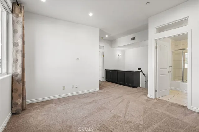 a view of an empty room and a window