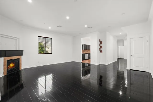 a view of dining room with wooden floor and a fireplace
