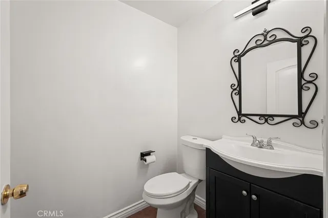 a bathroom with a sink toilet and a mirror