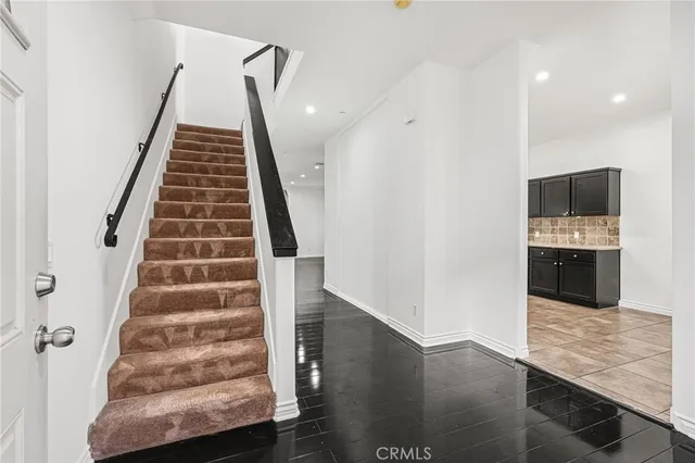 a view of a kitchen with wooden floor and electronic appliances