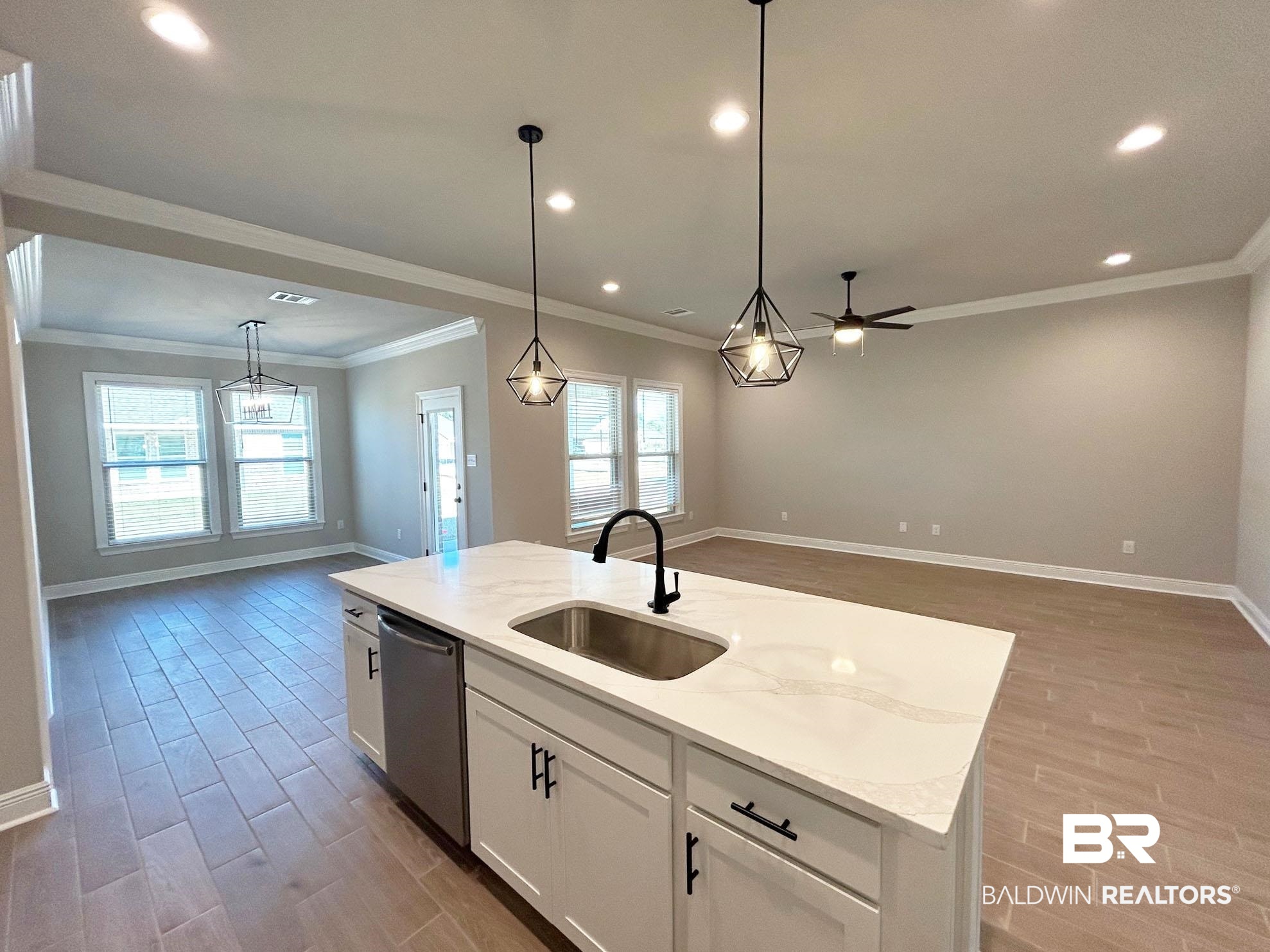 877 Sumter Loop Foley, AL 36535 - Photo 17 of 18 Kitchen featuring a sink, stainless steel dishwasher, open floor plan, and light wood finished floors