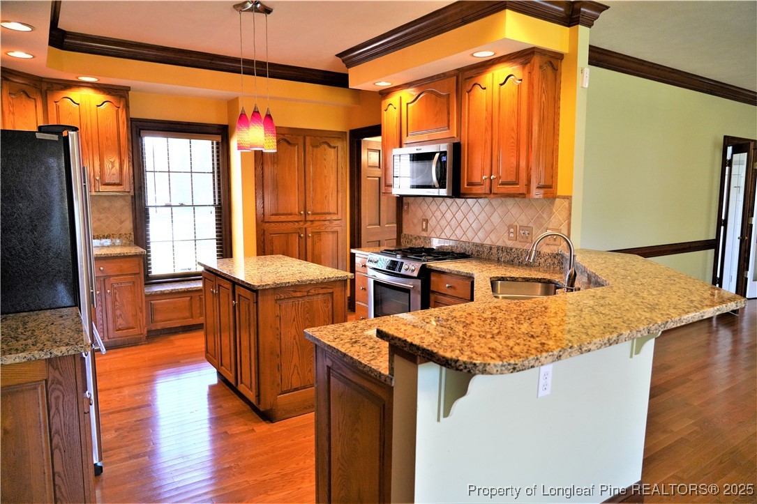 568 Broyhill Road Fayetteville, NC 28314 - Photo 12 of 37 a kitchen with a sink stove and a refrigerator
