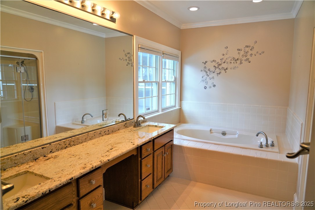568 Broyhill Road Fayetteville, NC 28314 - Photo 19 of 37 a bathroom with a granite countertop sink and a bathtub