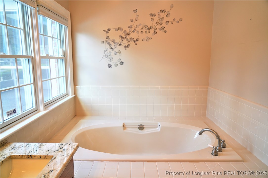 568 Broyhill Road Fayetteville, NC 28314 - Photo 20 of 37 a bathroom with bathtub and window
