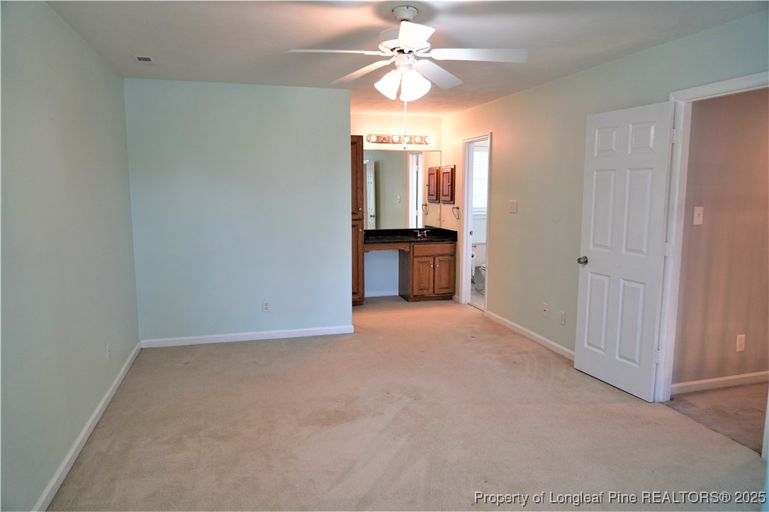 568 Broyhill Road Fayetteville, NC 28314 - Photo 24 of 37 a view of a room with a ceiling fan and a bathroom