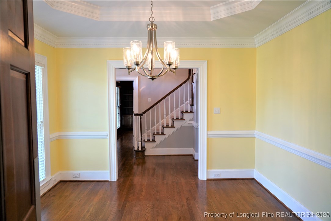 568 Broyhill Road Fayetteville, NC 28314 - Photo 6 of 37 a view of a hallway with wooden floor and chandelier