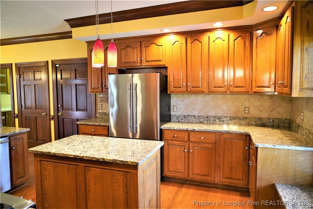 568 Broyhill Road Fayetteville, NC 28314 - Photo 8 of 37 a kitchen with a stove a sink and a refrigerator
