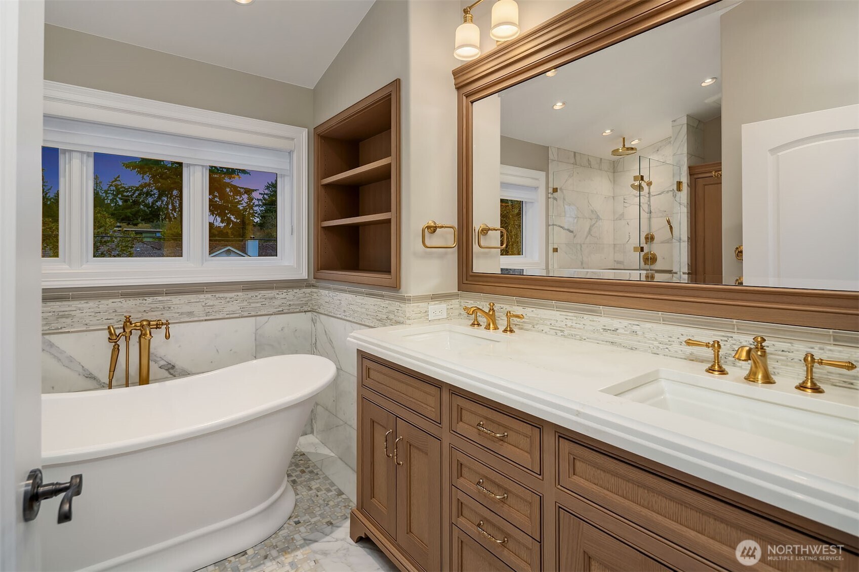 854 Evergreen Point Road Medina, WA 98039 - Photo 20 of 40 a bathroom with a sink and a large mirror