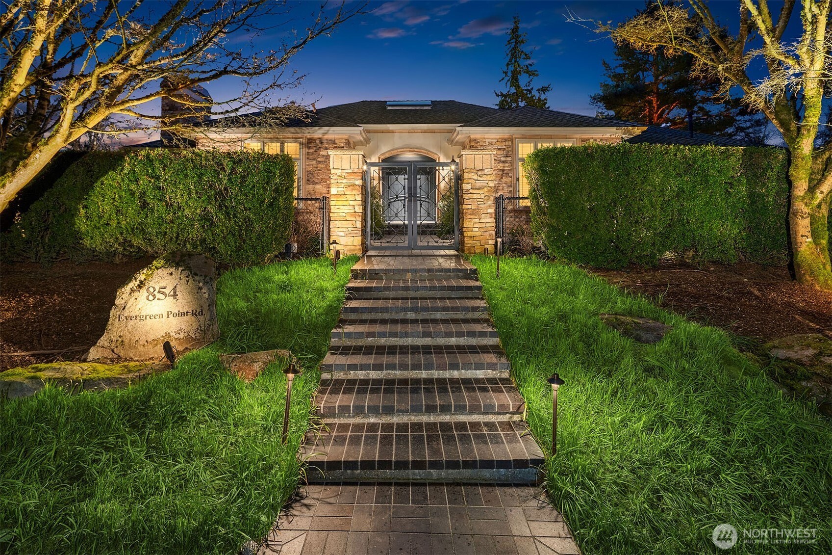 854 Evergreen Point Road Medina, WA 98039 - Photo 2 of 40 a front view of a house with a yard