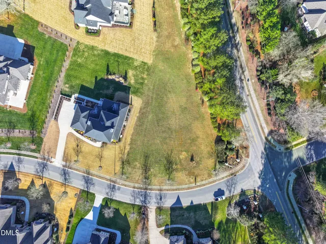 a white vase of flowers sitting on a floor