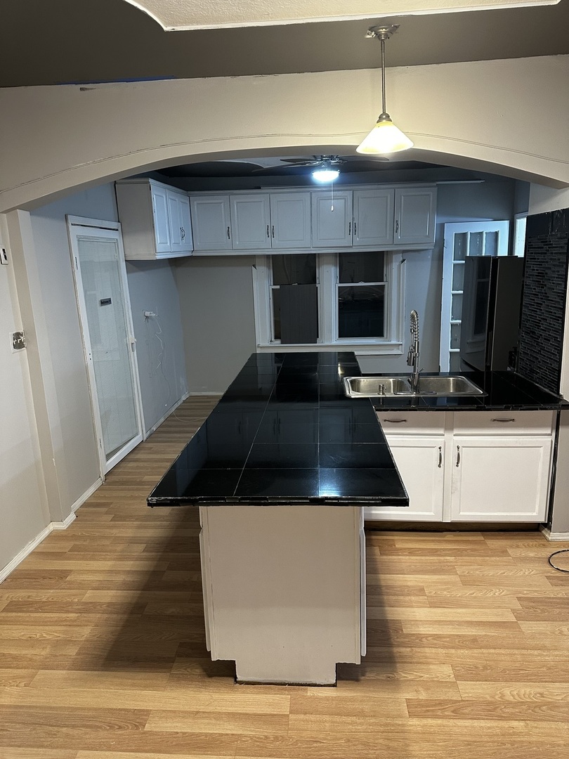 435 South Poplar Avenue Kankakee, IL 60901 - Photo 18 of 45 a kitchen with kitchen island a counter top a stove and a sink
