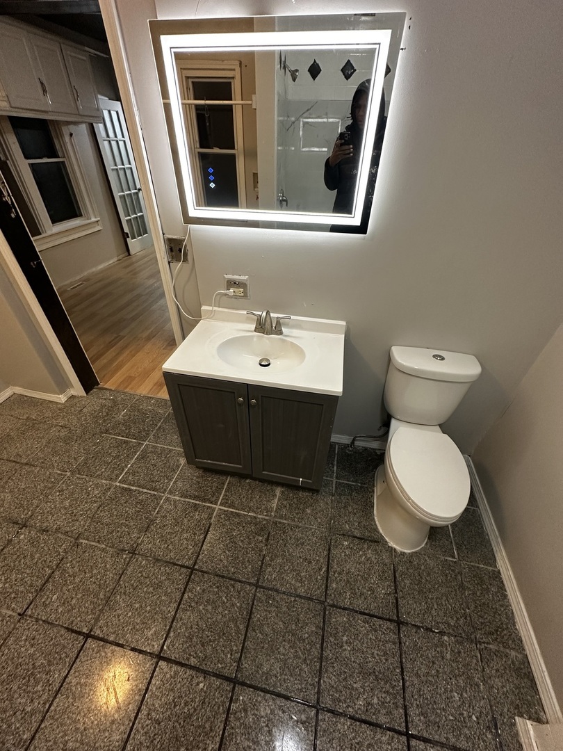 435 South Poplar Avenue Kankakee, IL 60901 - Photo 24 of 45 a bathroom with a toilet sink and mirror