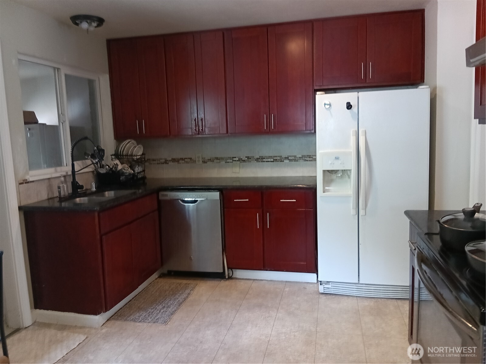 522 Northeast 127th Street Seattle, WA 98125 - Photo 16 of 28 a kitchen with a sink and a refrigerator