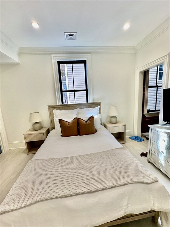 6 Douglas Street, Unit 1L Boston, MA 02127 - Photo 11 of 16 a bedroom with a bed and a window