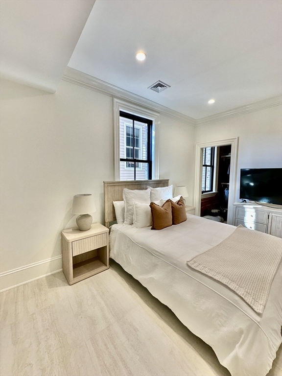 6 Douglas Street, Unit 1L Boston, MA 02127 - Photo 12 of 16 a bedroom with a bed and a flat screen tv